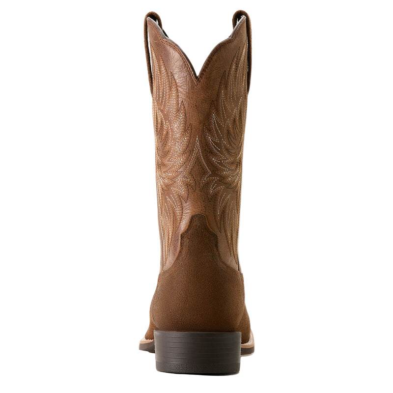 Brown cowboy boot with intricate design on a beige background
