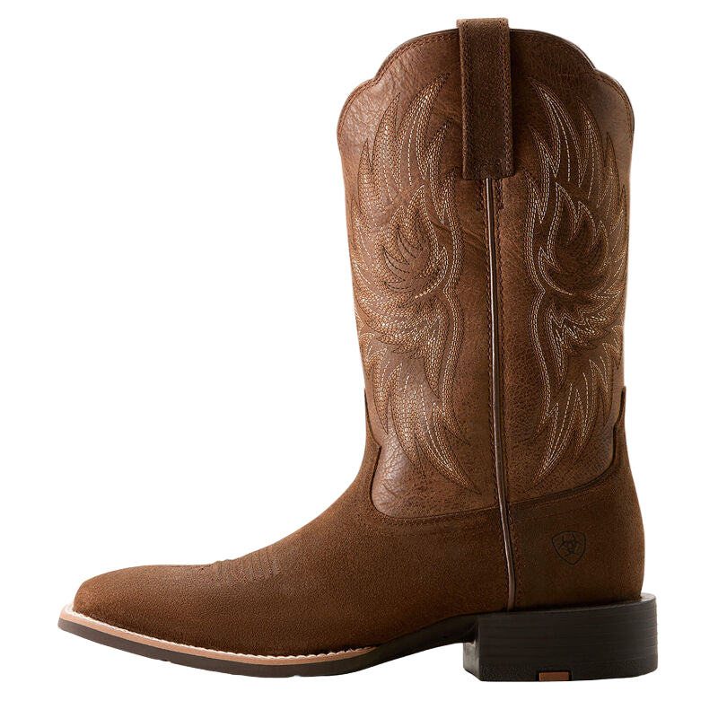 Brown cowboy boot with intricate embossing on a white background