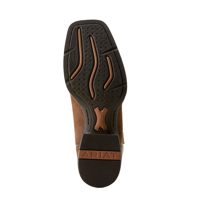 Close-up of a brown boot sole with Ariat branding on a beige background
