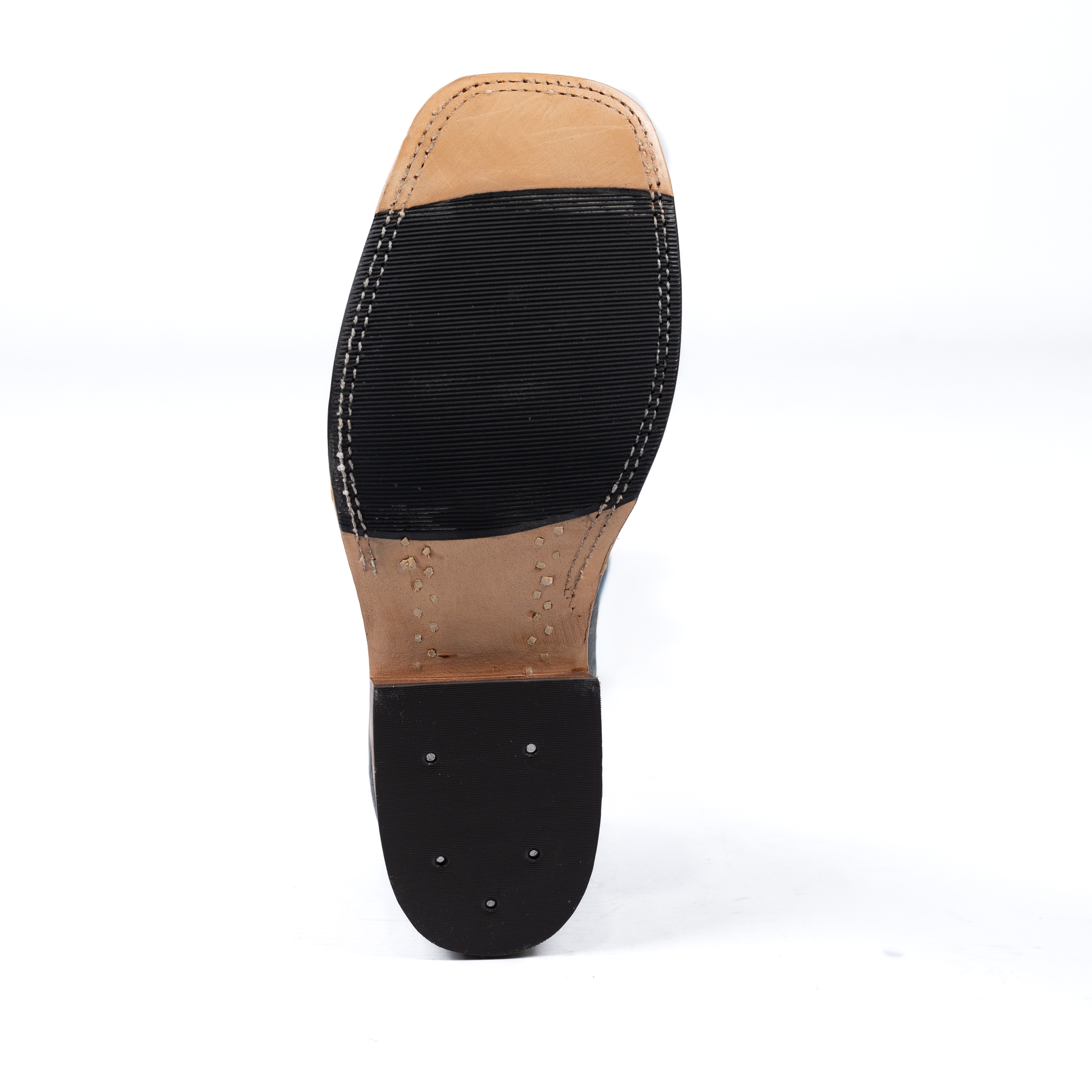 Close-up of a shoe sole with black rubber and tan leather on a white background