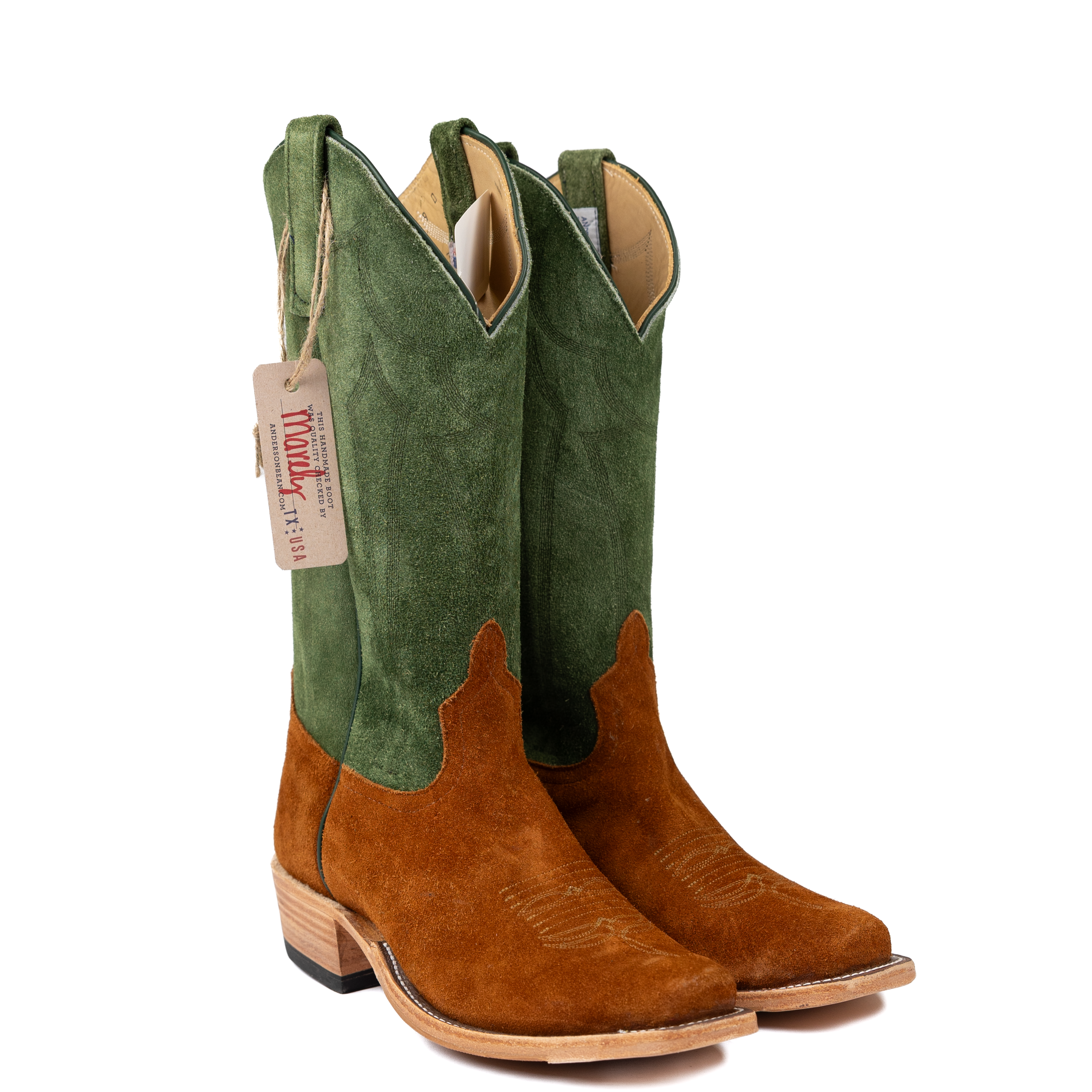Green and brown cowboy boots with a visible brand tag on a white background