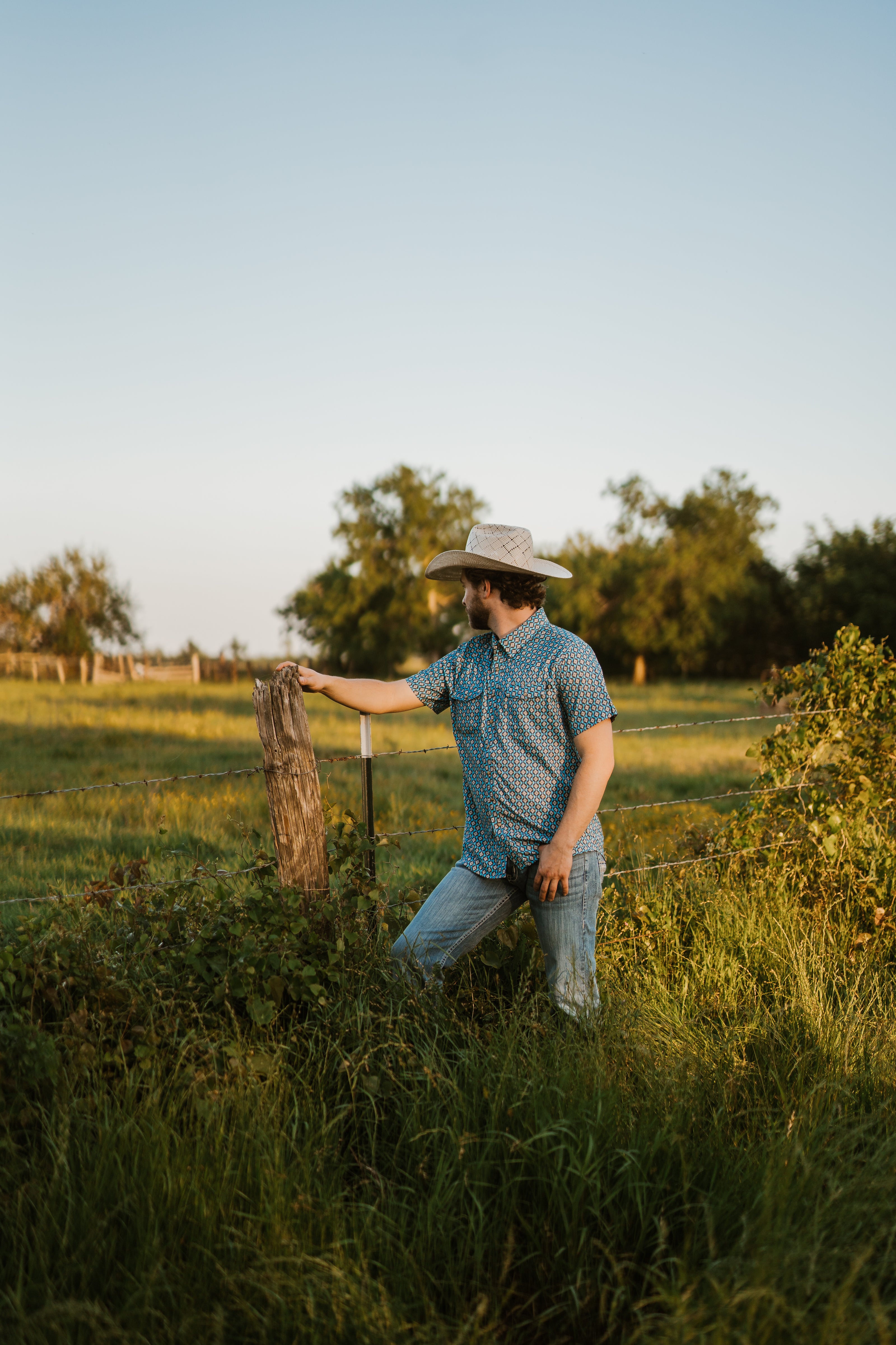 Man in a cowboy hat standing in a field