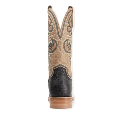 Close-up of a black and tan cowboy boot with intricate patterns on a white background