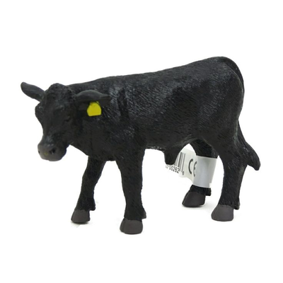 Black cow toy with a yellow tag on a white background
