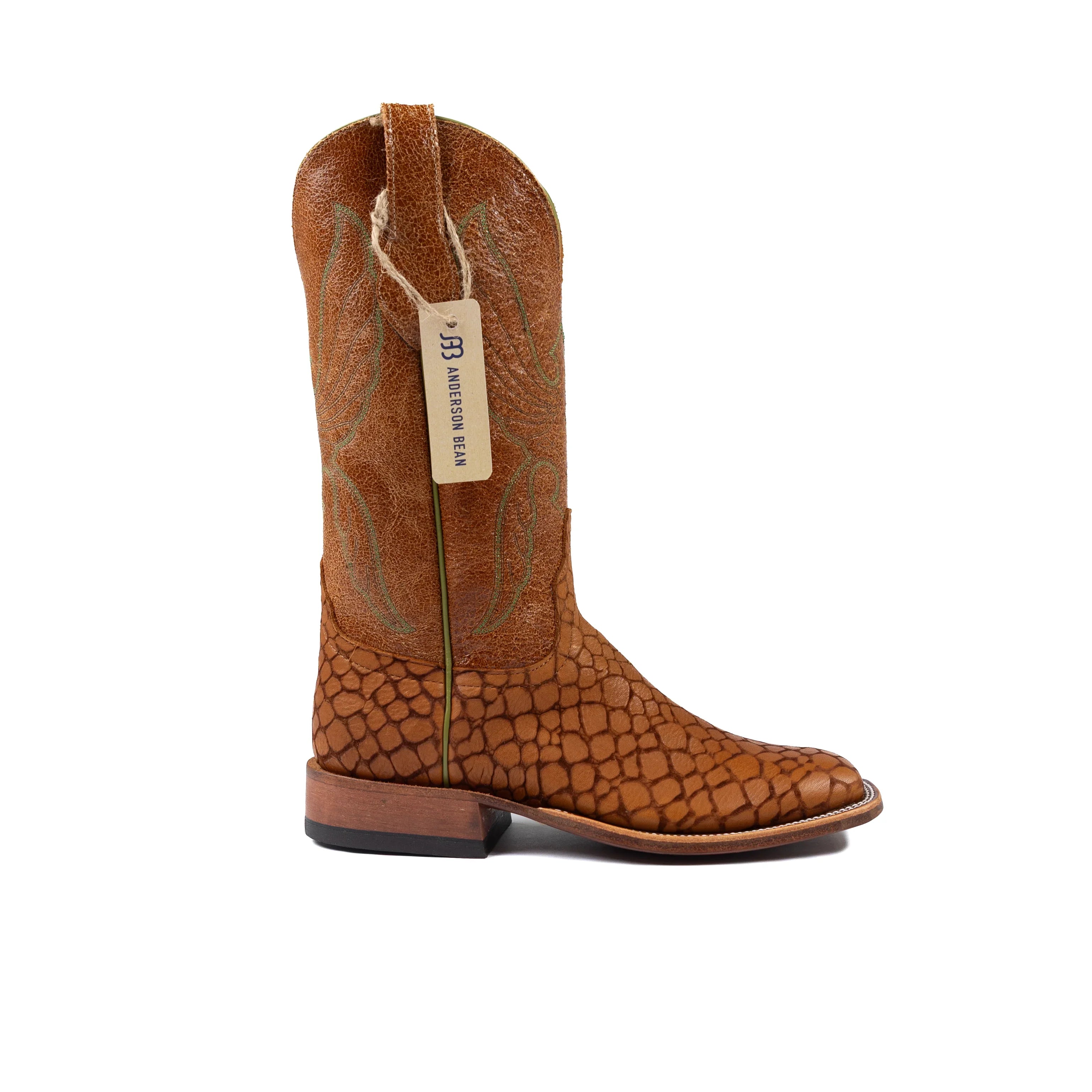 Brown cowboy boot with a visible brand tag on a white background