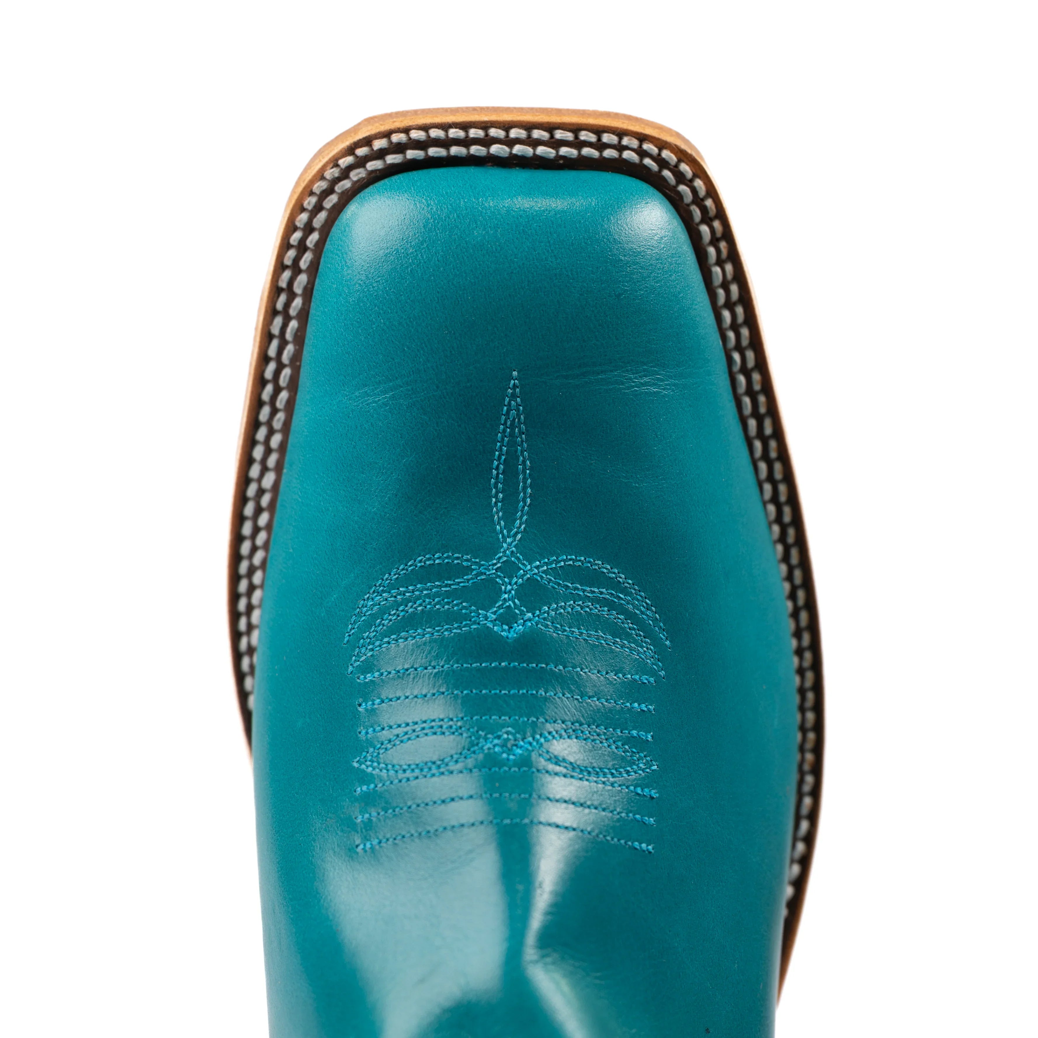 Close-up of a turquoise cowboy boot with decorative stitching on a white background