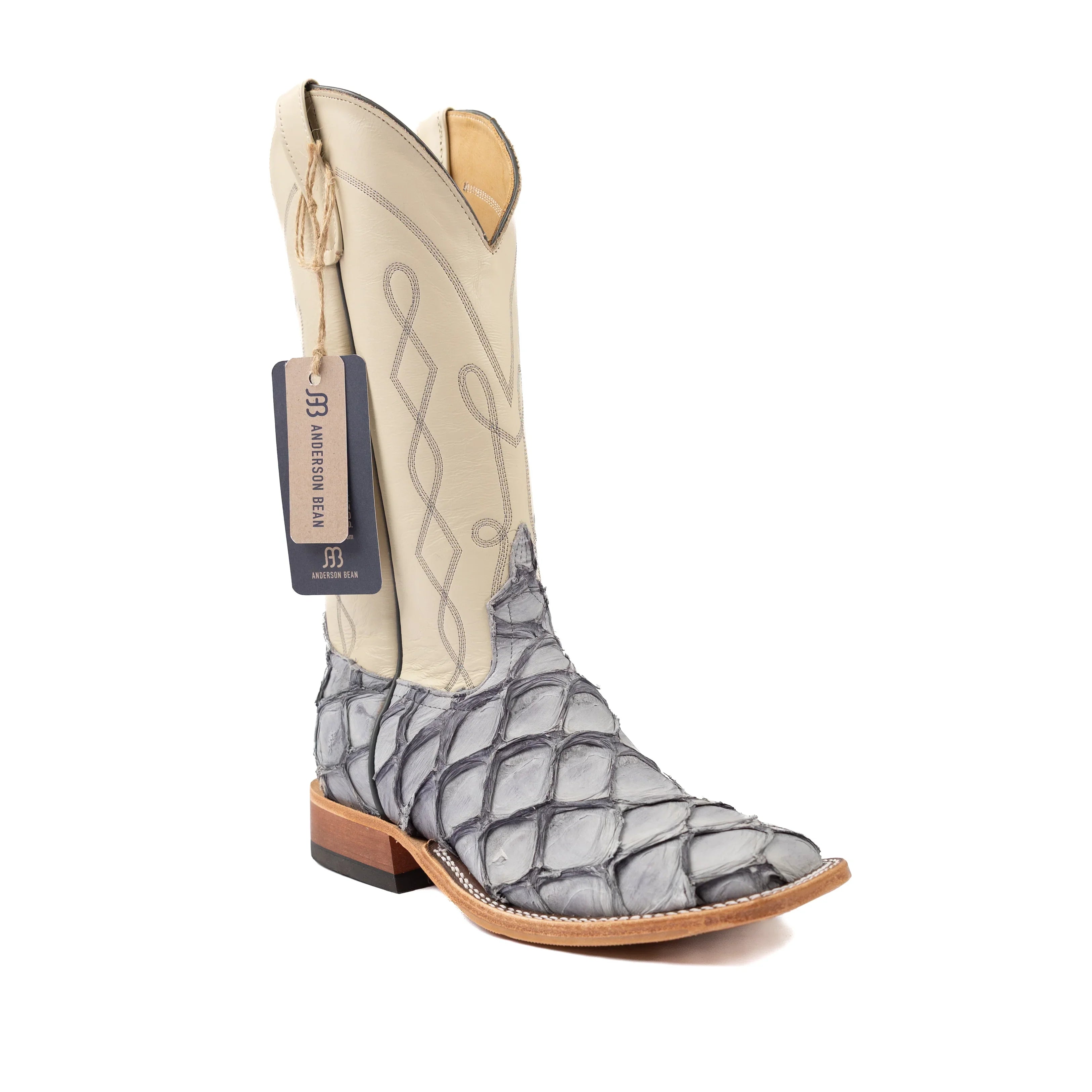 Cowboy boot with a patterned toe and beige shaft on a white background