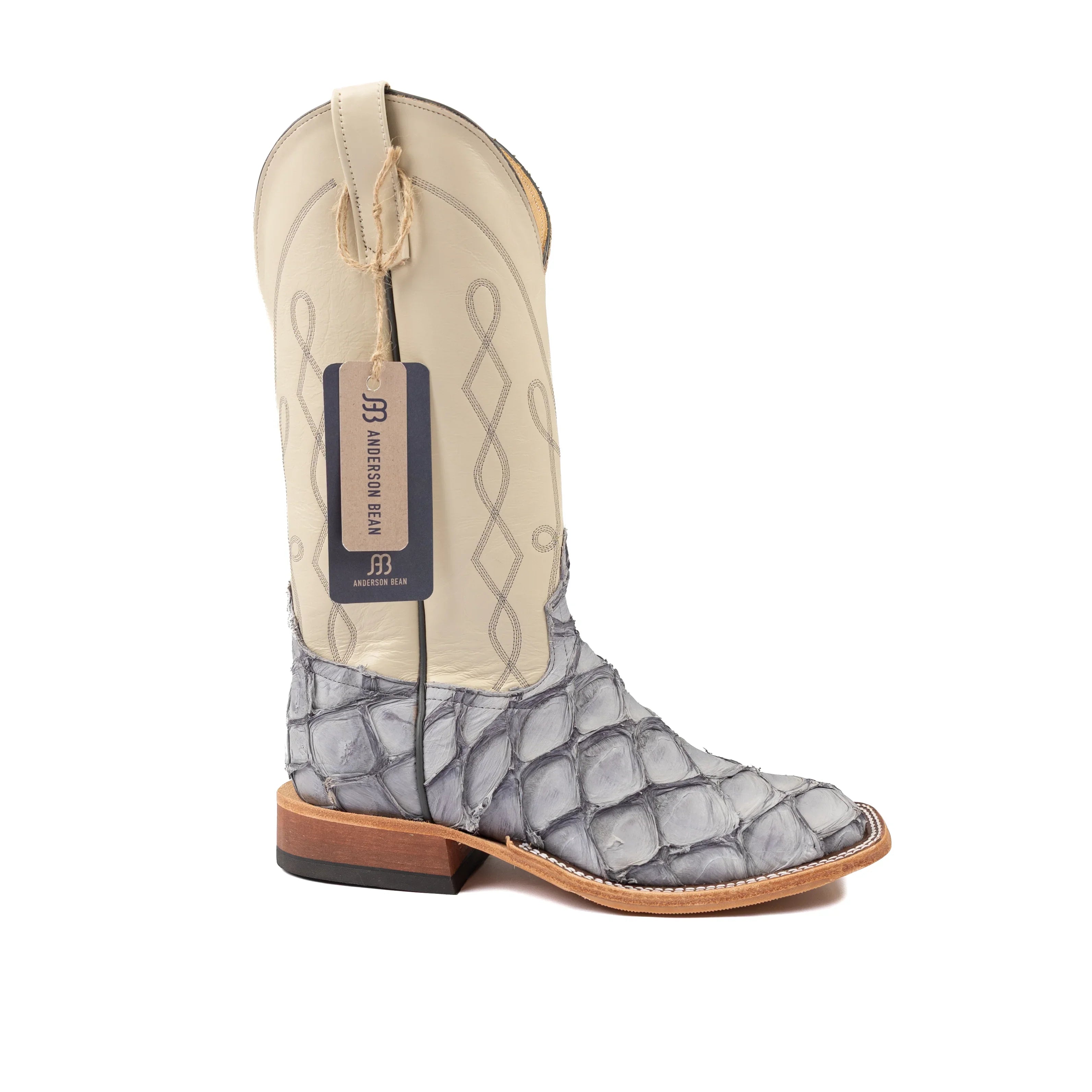 Cowboy boot with a patterned toe and beige shaft on a white background