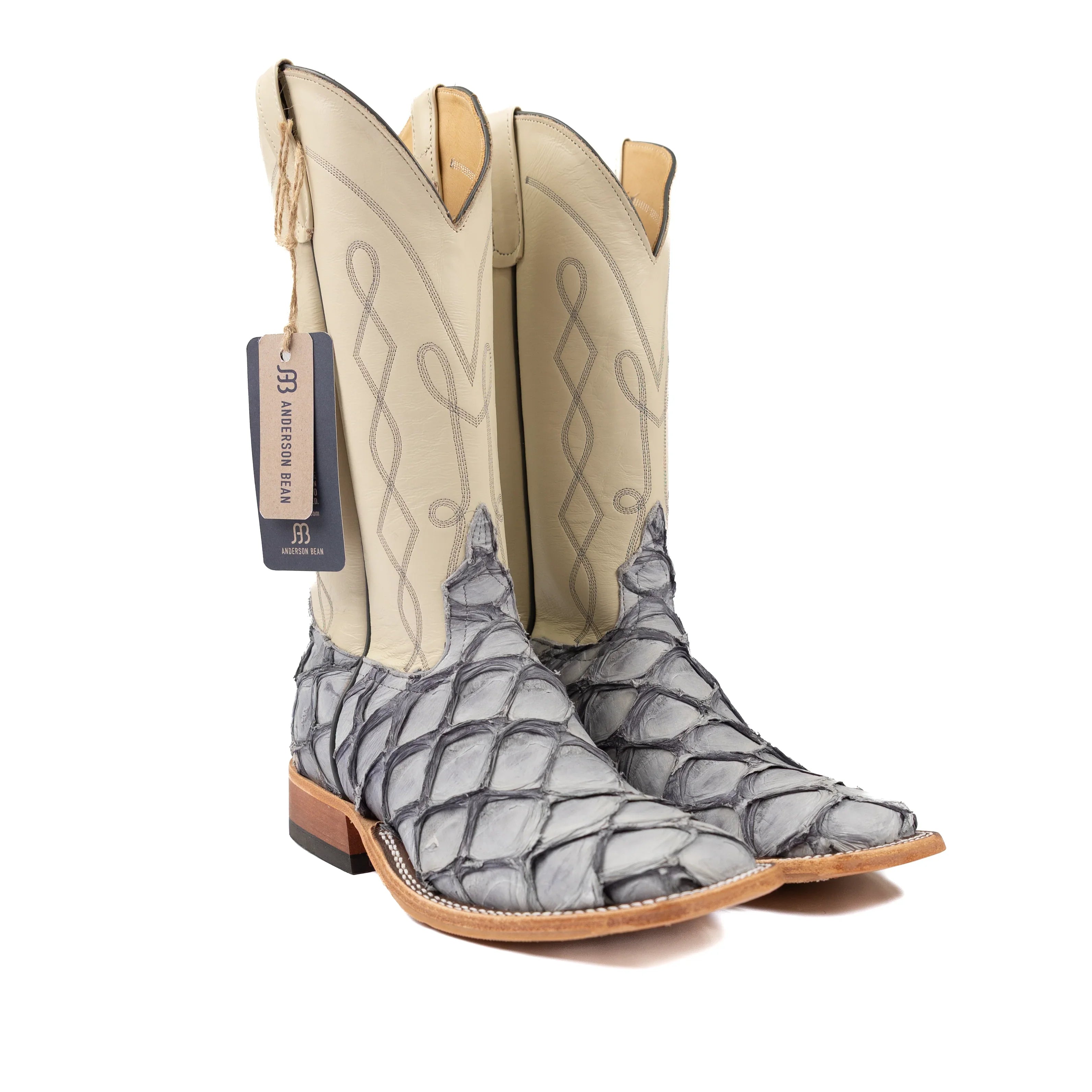 Cowboy boots with a patterned sole on a white background