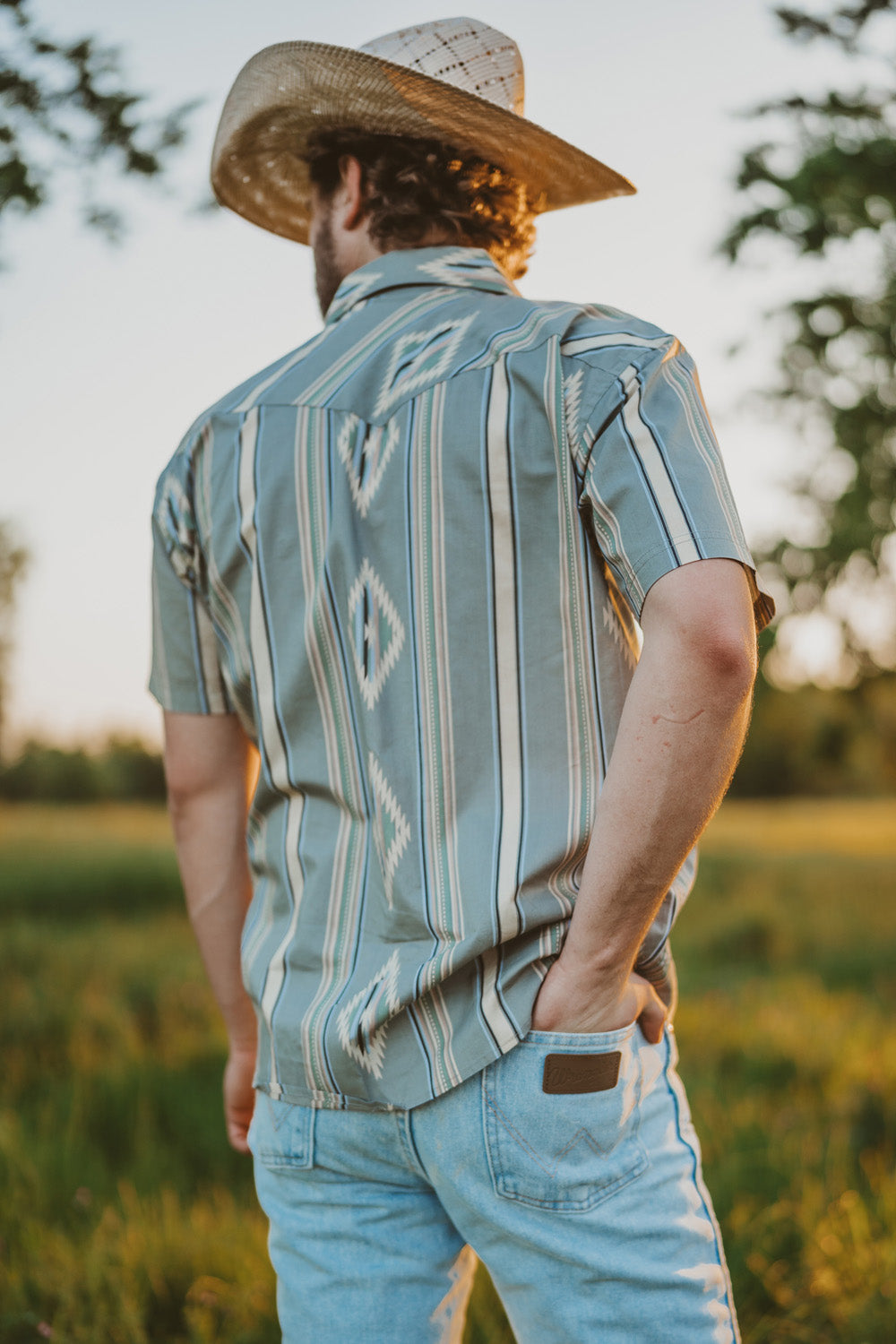 Man wearing a cowboy hat and wearing western clothing.