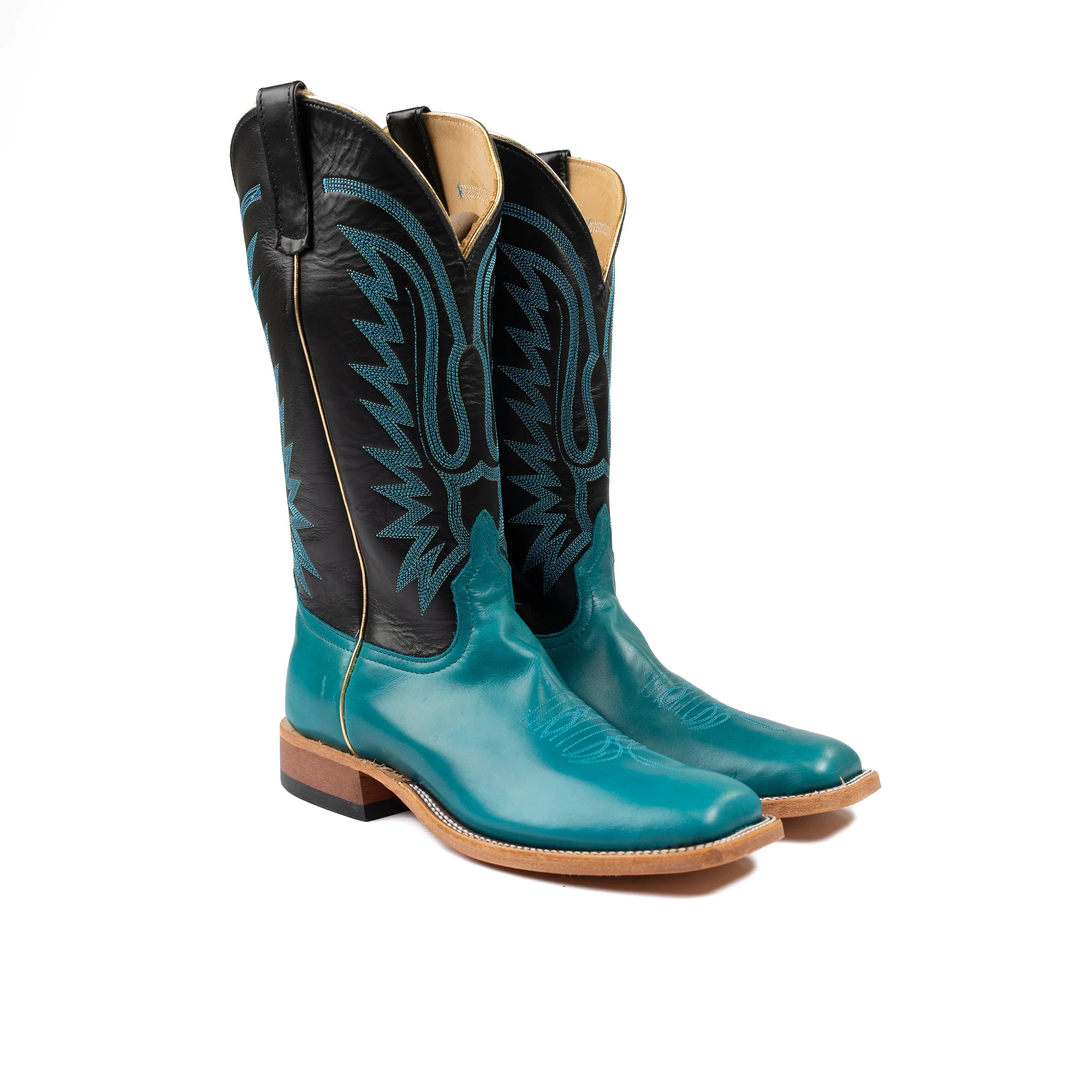 Turquoise and black cowboy boots on a white background