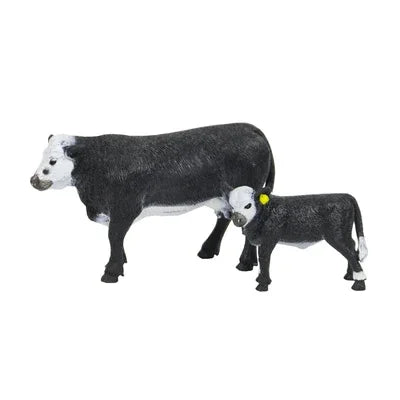 Two cow figurines on a white background