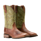 Pair of brown and green cowboy boots with intricate designs on a beige background