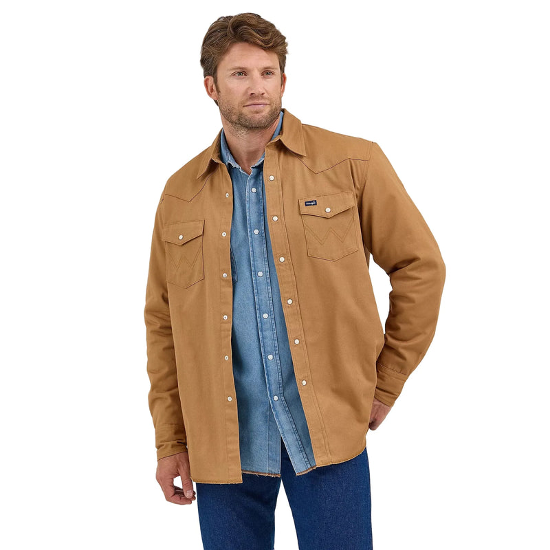 Man wearing a brown jacket over a blue shirt on a white background
