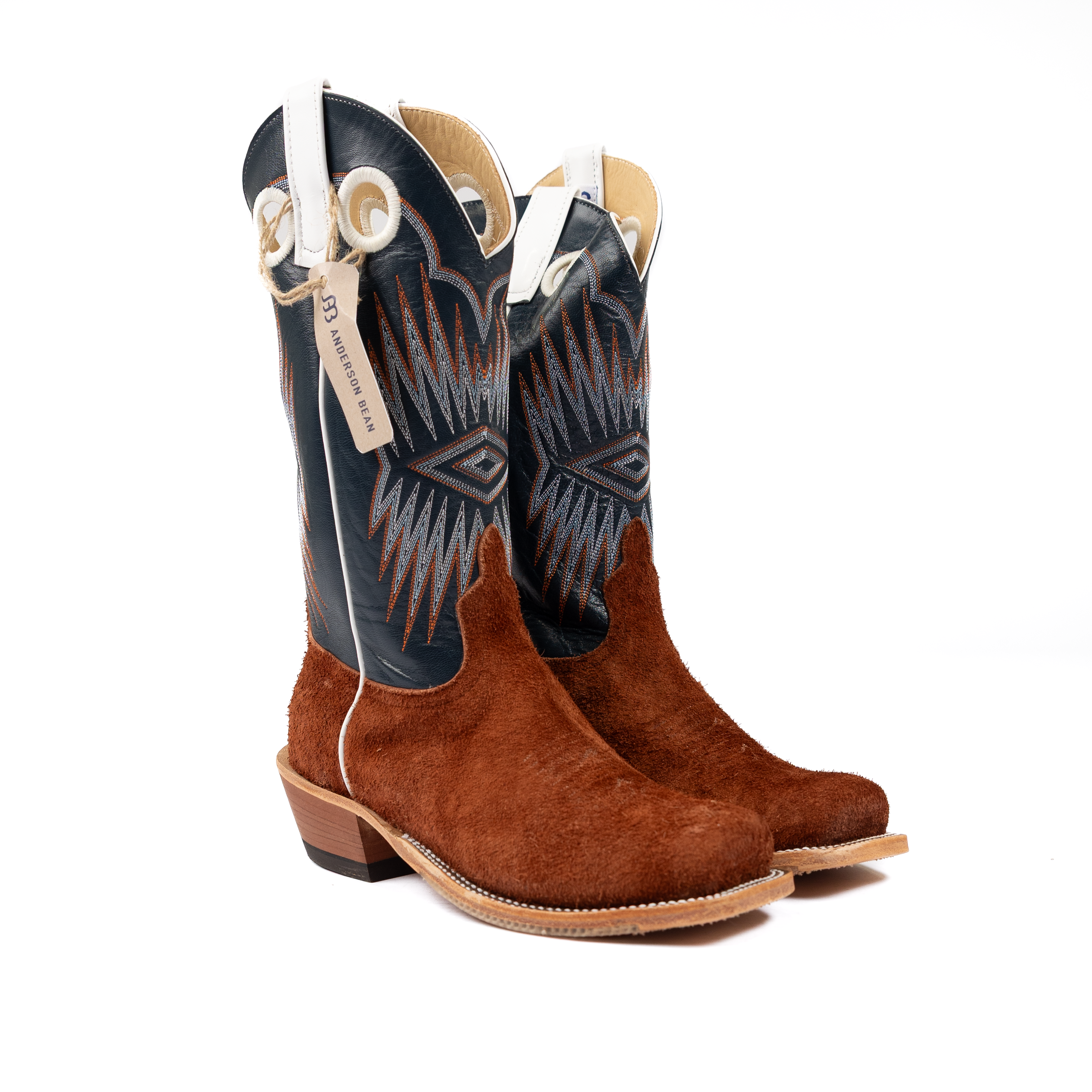 Pair of brown and blue cowboy boots with a visible brand tag on a white background