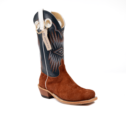 Brown cowboy boot with blue decorative side panel on a white background