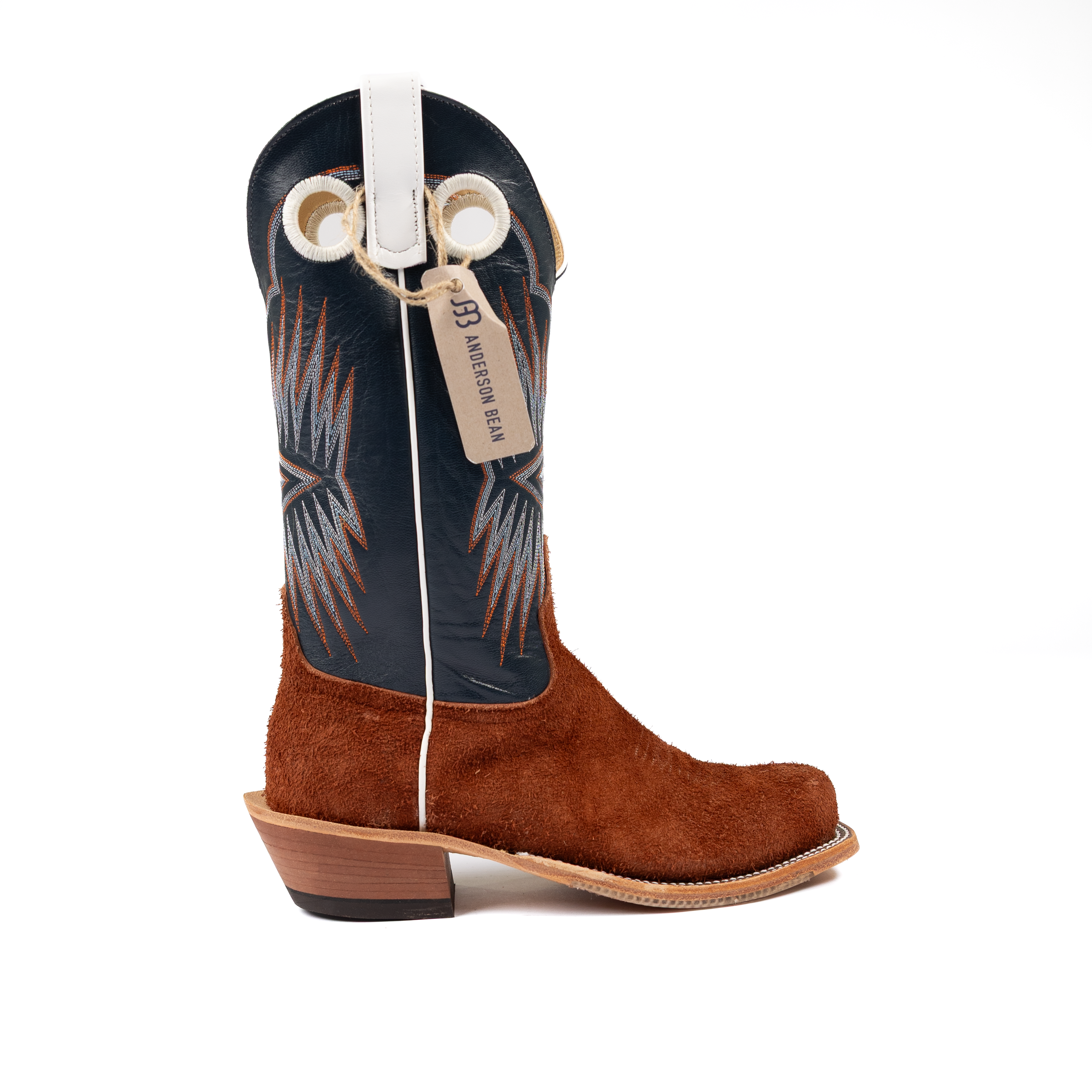 Brown cowboy boot with a black and white pattern on a white background