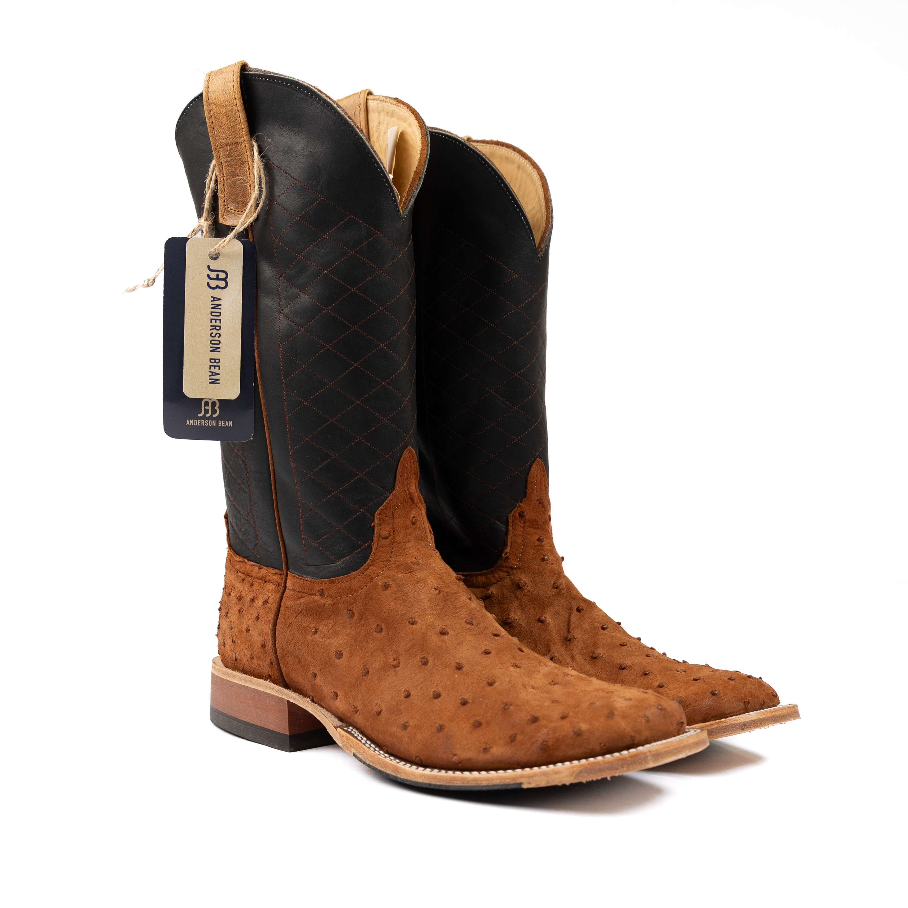 Pair of brown cowboy boots with a black insole on a white background