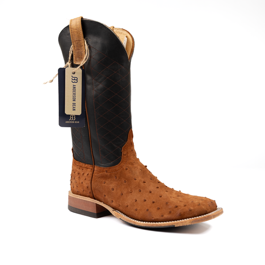 Brown cowboy boot with black interior on a white background