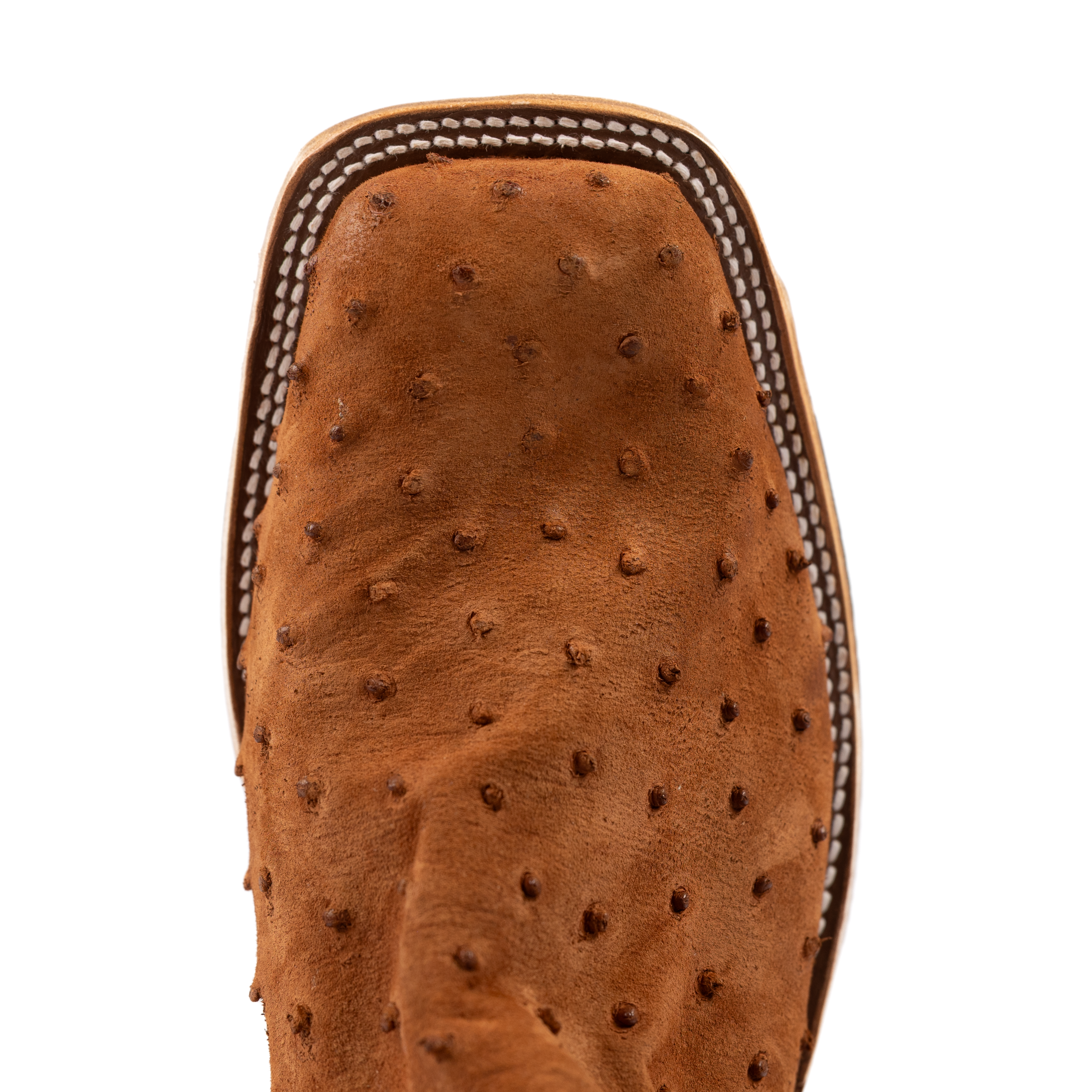 Close-up of a brown leather boot sole with a textured pattern on a white background