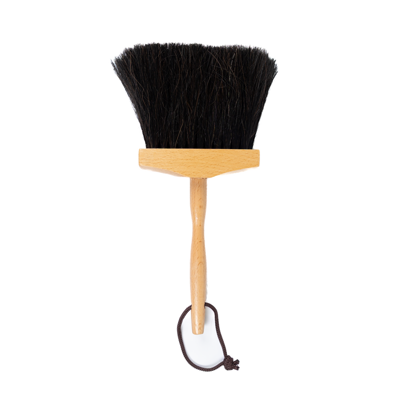 Black bristle brush with wooden handle on a white background