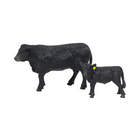 Two black cow figurines on a white background