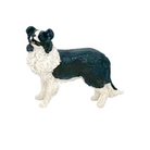 Dog figurine with black and white coat on a white background