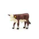 Model of a cow with a yellow tag on a white background
