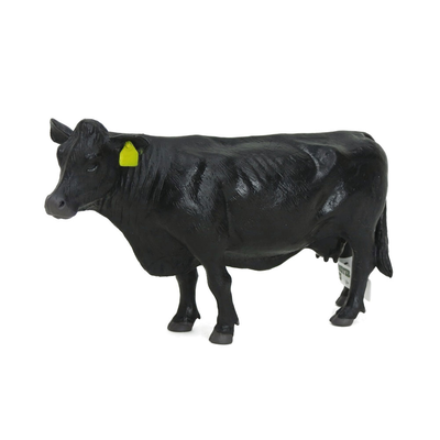 Black cow figurine with a yellow tag on a white background