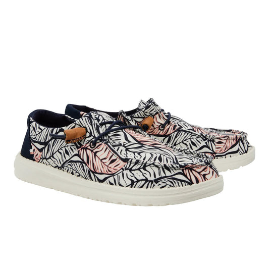 Pair of sneakers with a tropical leaf pattern on a white background