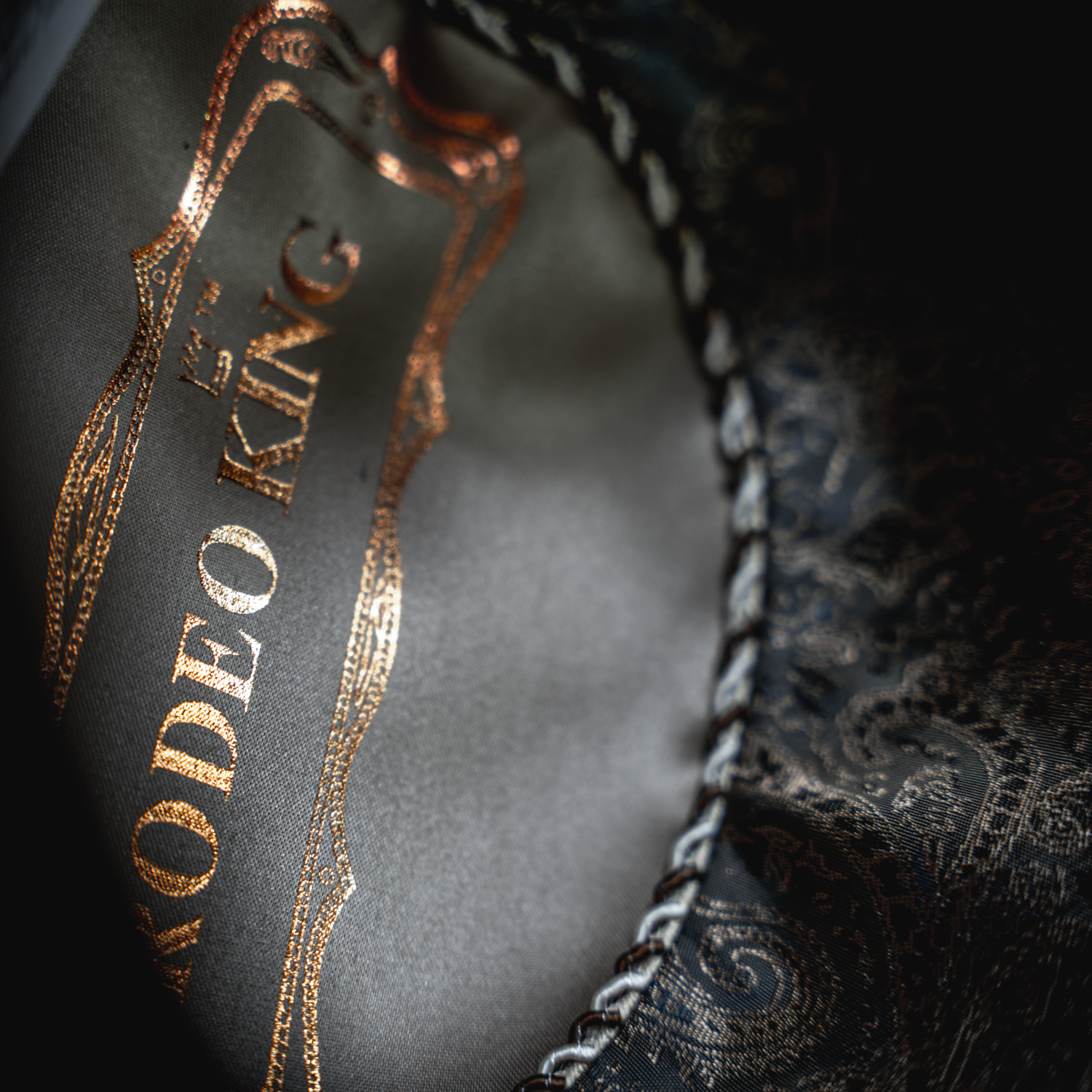 Close-up of a label on a garment with text and decorative elements.